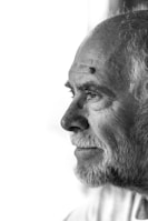 a black and white photo of a man with a beard