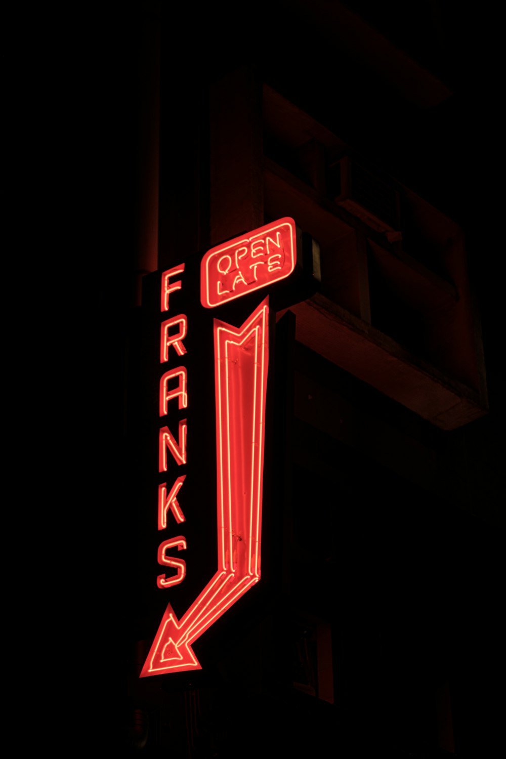 a neon sign on the side of a building