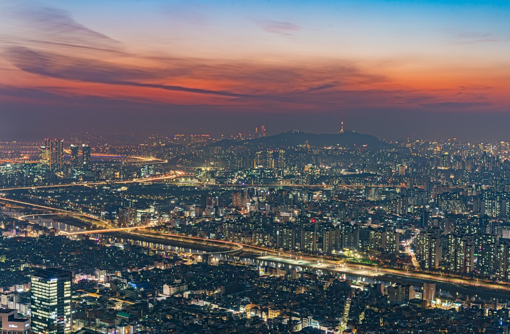 a view of a city at night from the top of a hill