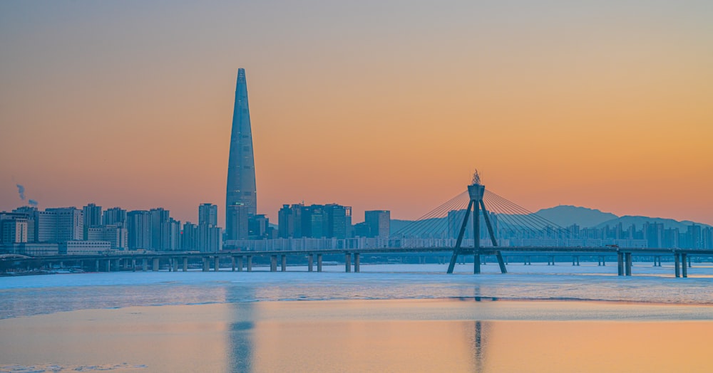 a city skyline with a bridge in the foreground