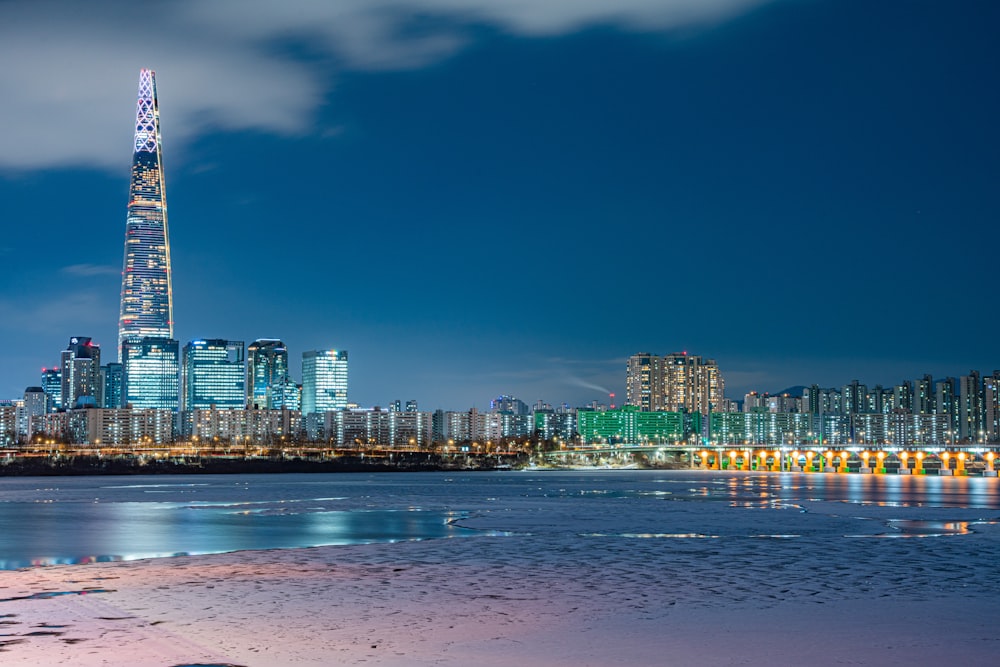 a view of a city at night from a beach