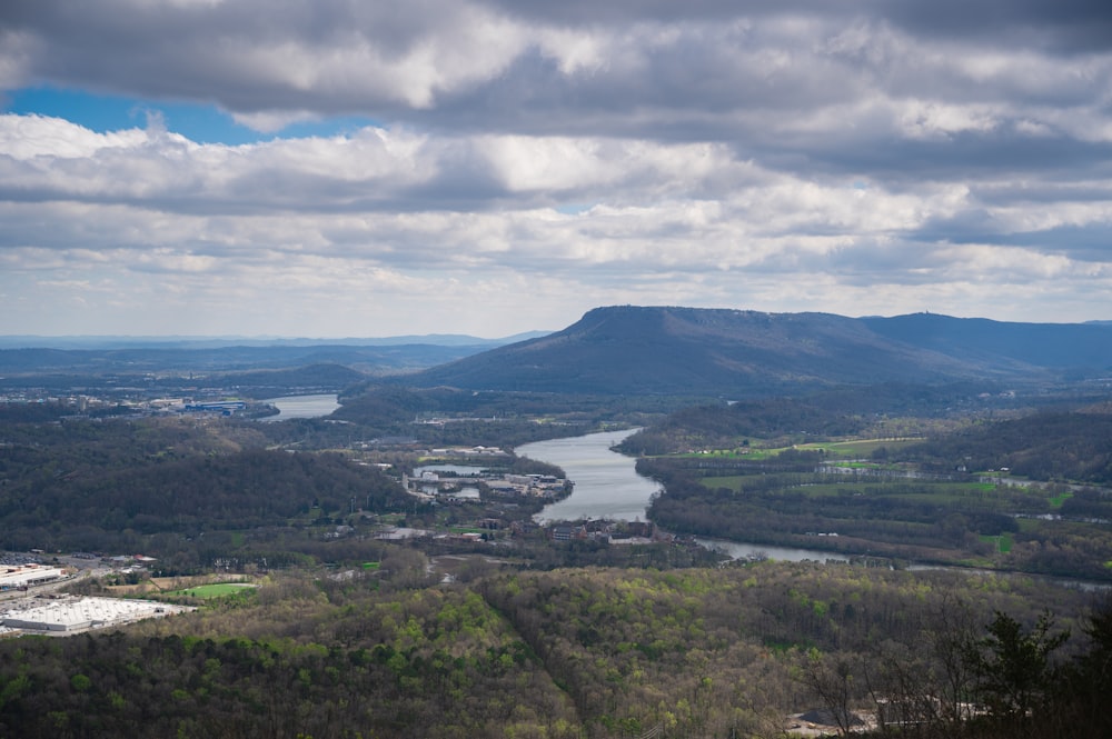 a scenic view of a river and mountains