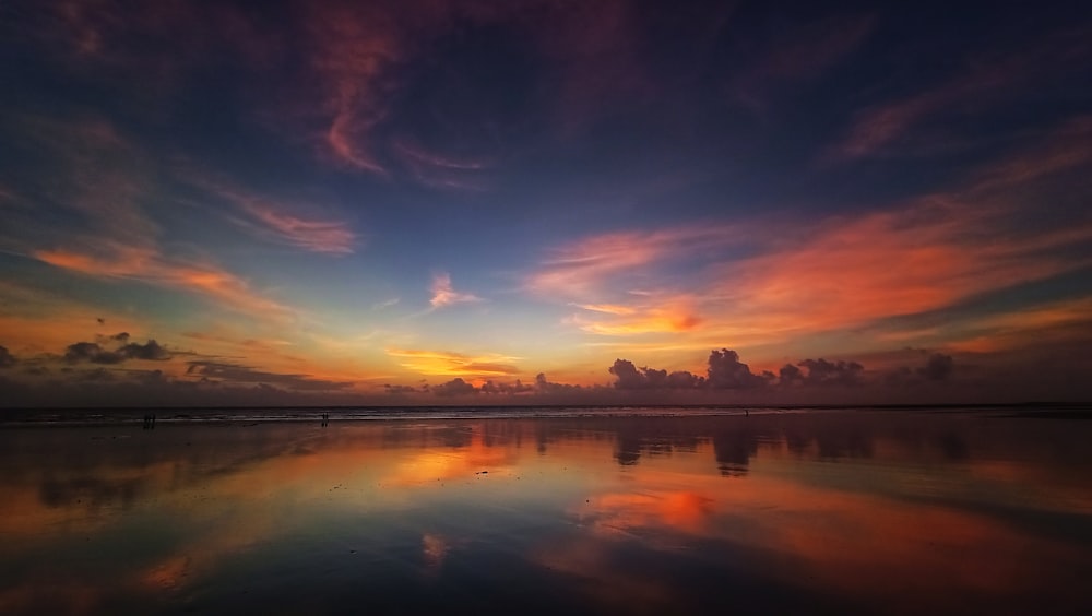 a beautiful sunset reflecting the clouds in the water