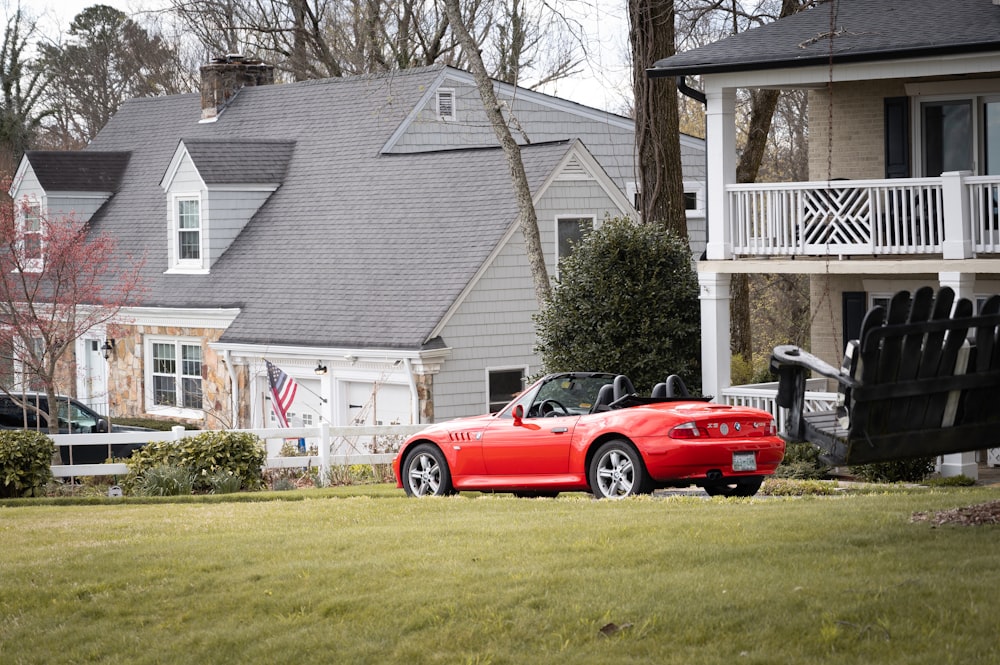 a red sports car parked in front of a house