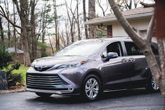 a gray car parked in front of a house