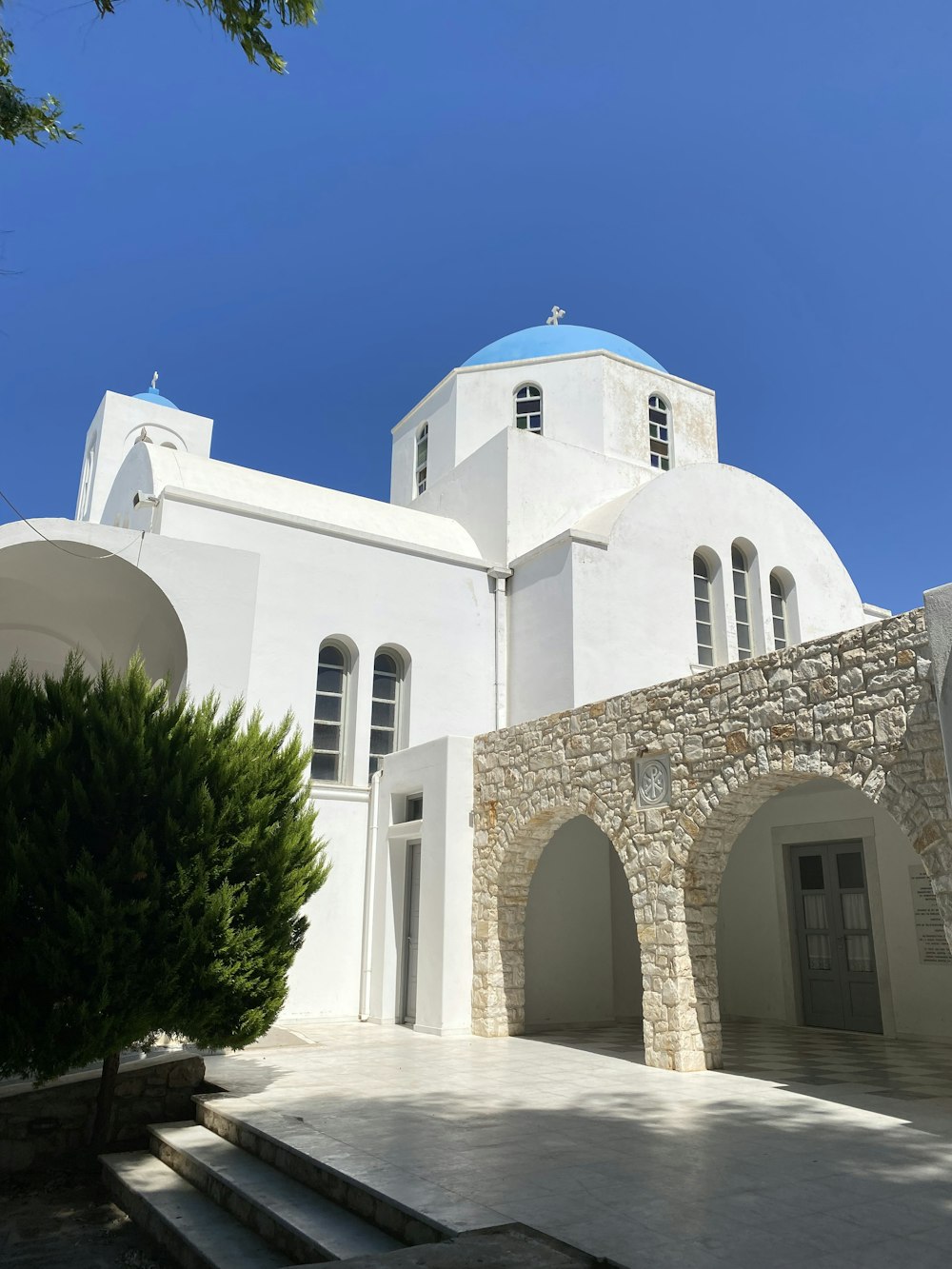 a white building with a blue dome on top of it