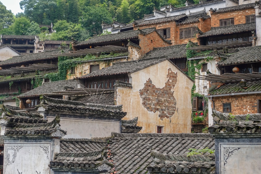 a group of buildings with a lot of trees in the background