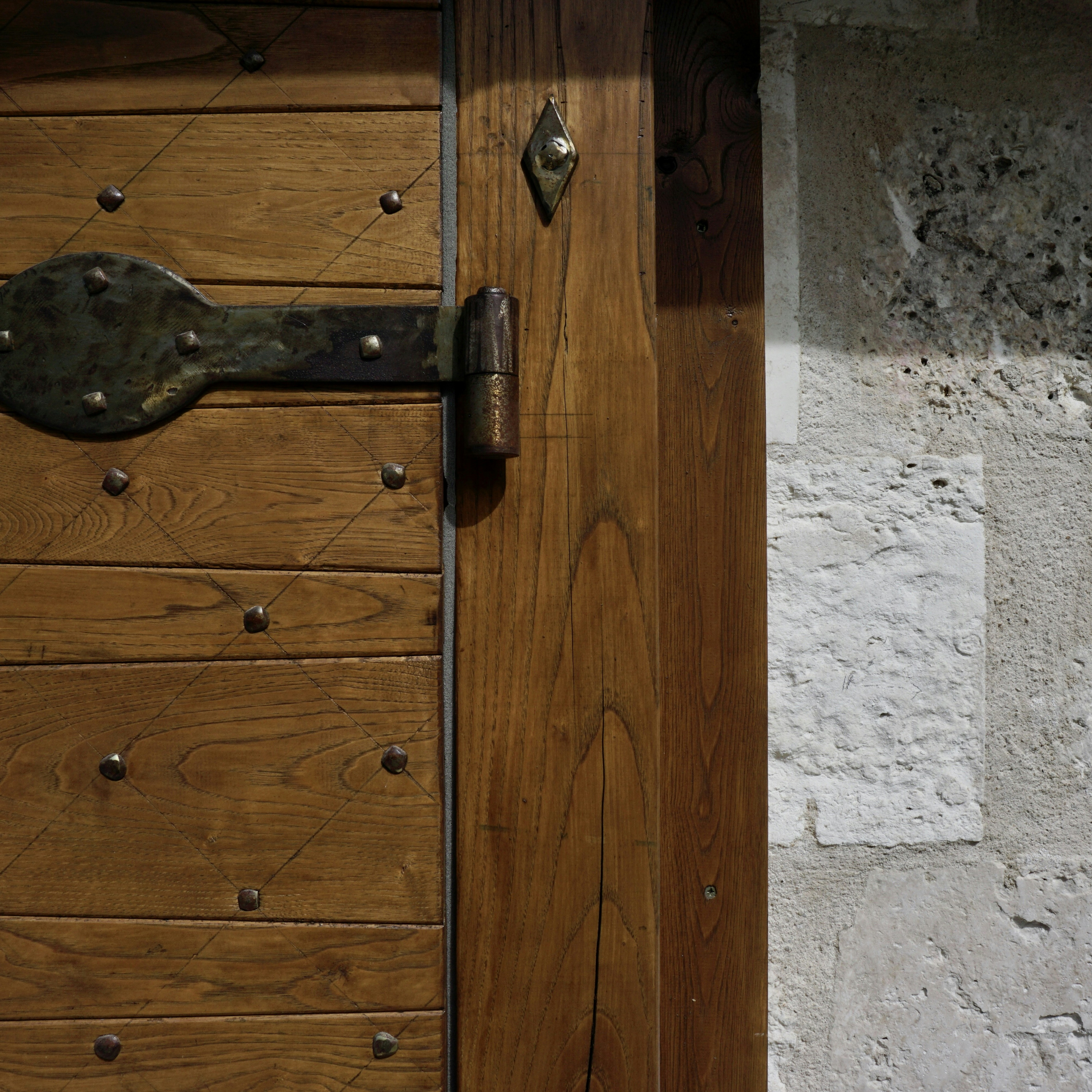 a close up of a wooden door with a metal handle