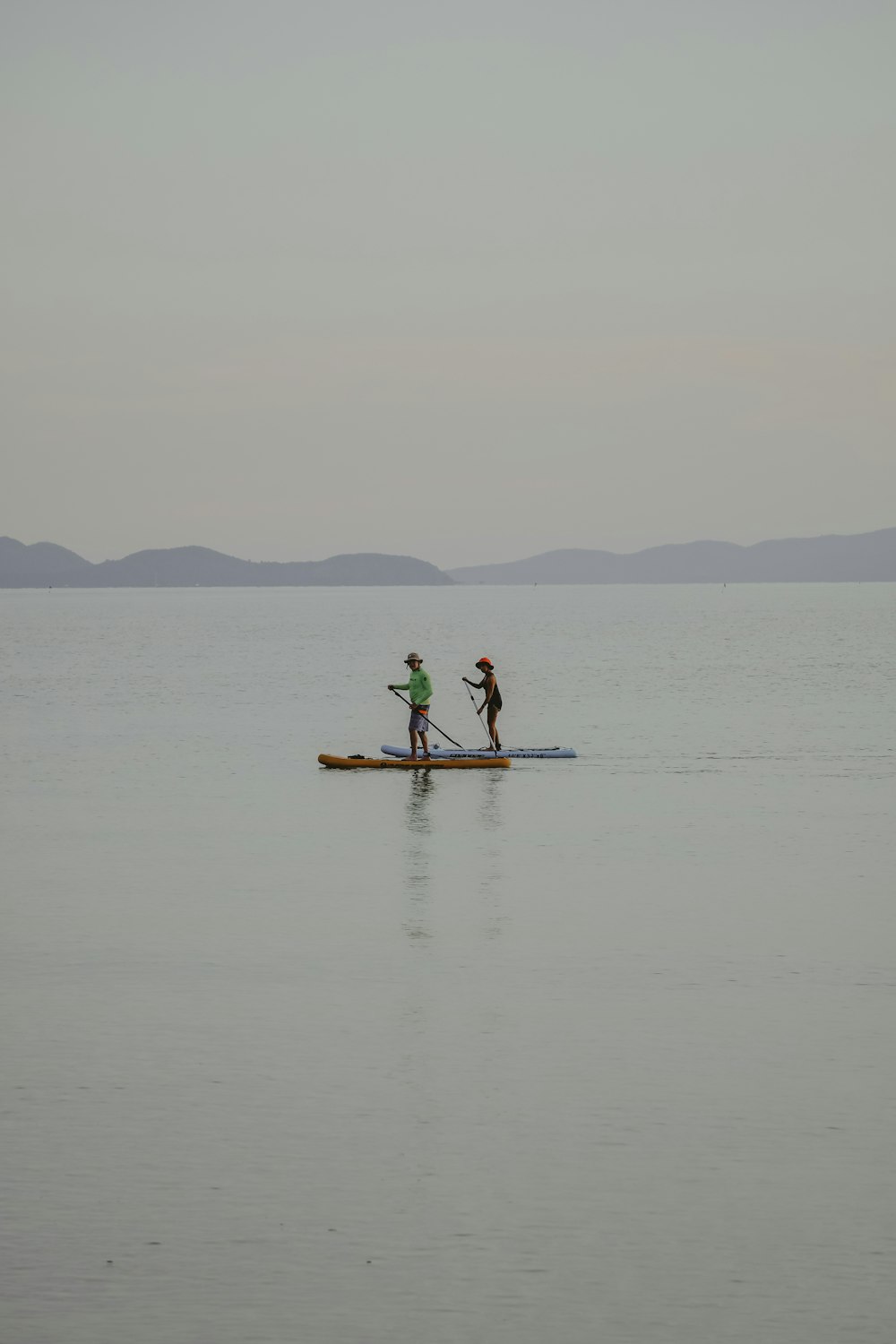 a couple of people on a small boat in the water