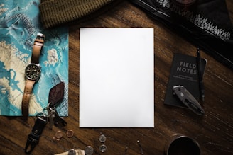 a notepad sitting on top of a wooden table next to a pair of scissors