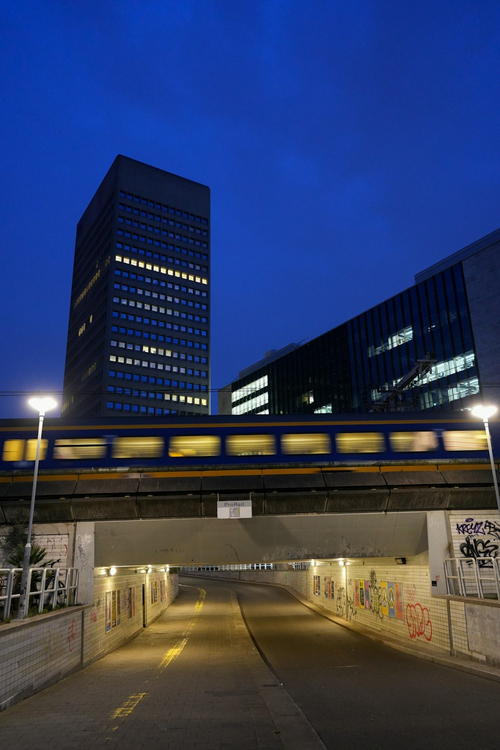 a train traveling over a bridge over a street