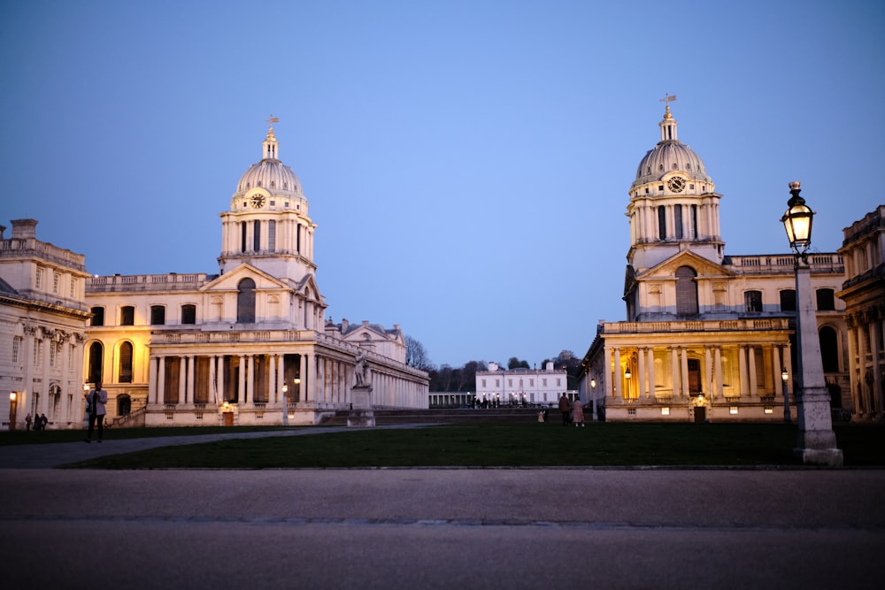 a large building with a clock tower at dusk