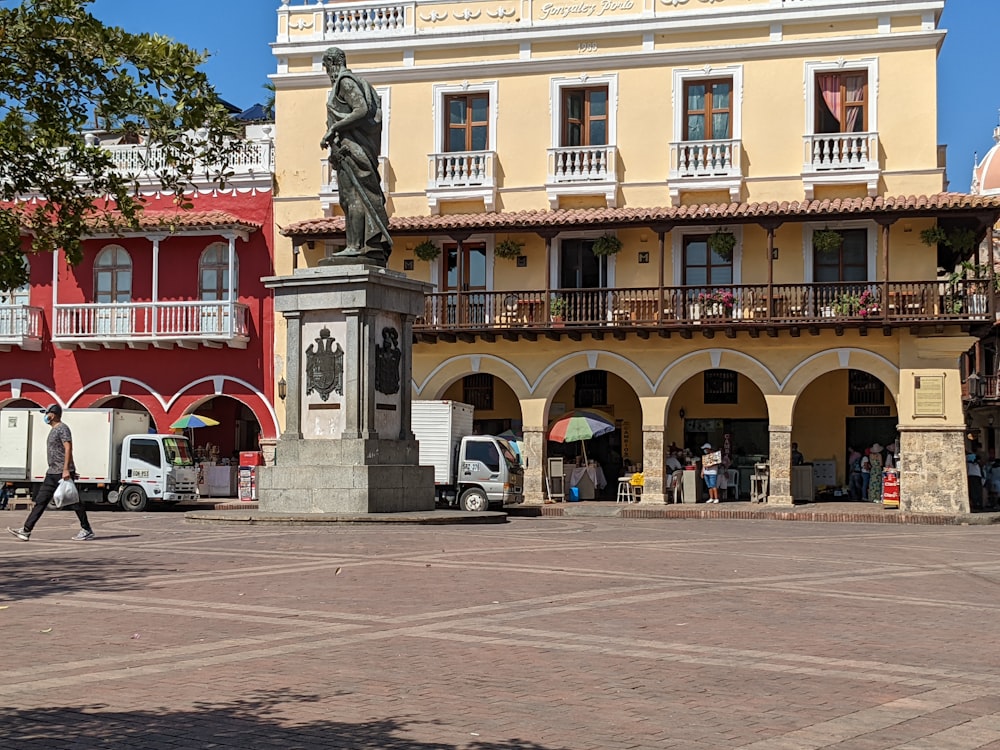 a large building with a statue in front of it