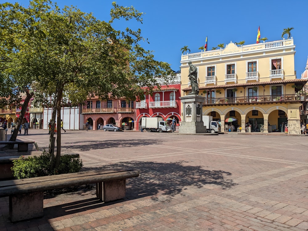 a city square with a bench in front of a building