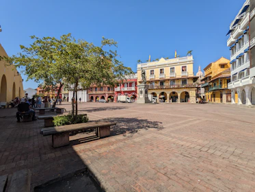 The vibrant colors of Cusco’s historic plaza under a clear blue sky, framed by colonial architecture.