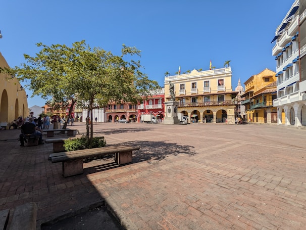 A peaceful plaza in a Tlalpan pueblo with families enjoying a sunny afternoon.