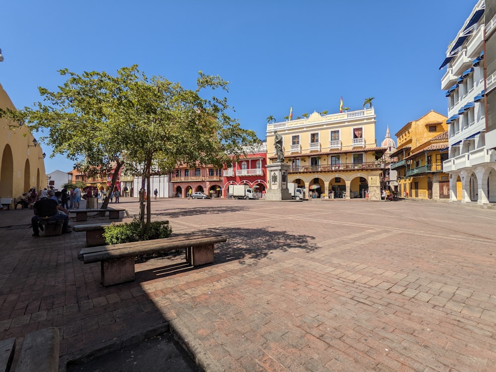 a city square with a bench in the middle of it