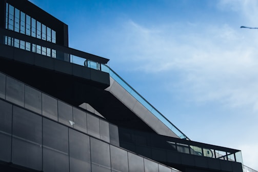 Architectural shot of a striking contemporary building against blue skies.