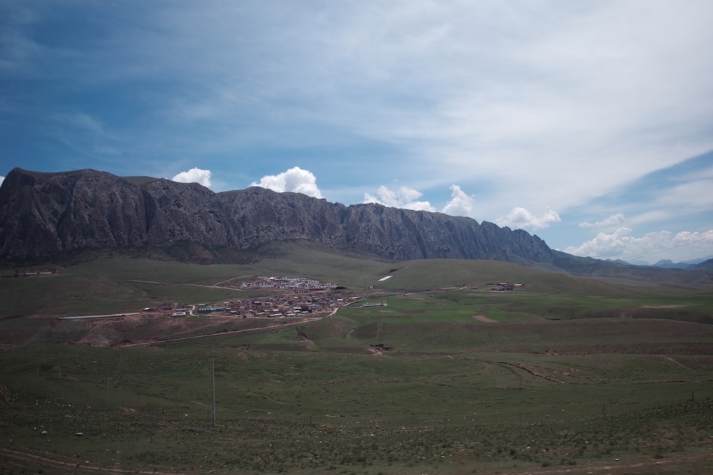 a mountain range with a small village in the foreground