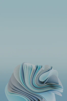 Delicately folded paper art creating layered geometric forms against a soft creamy background.