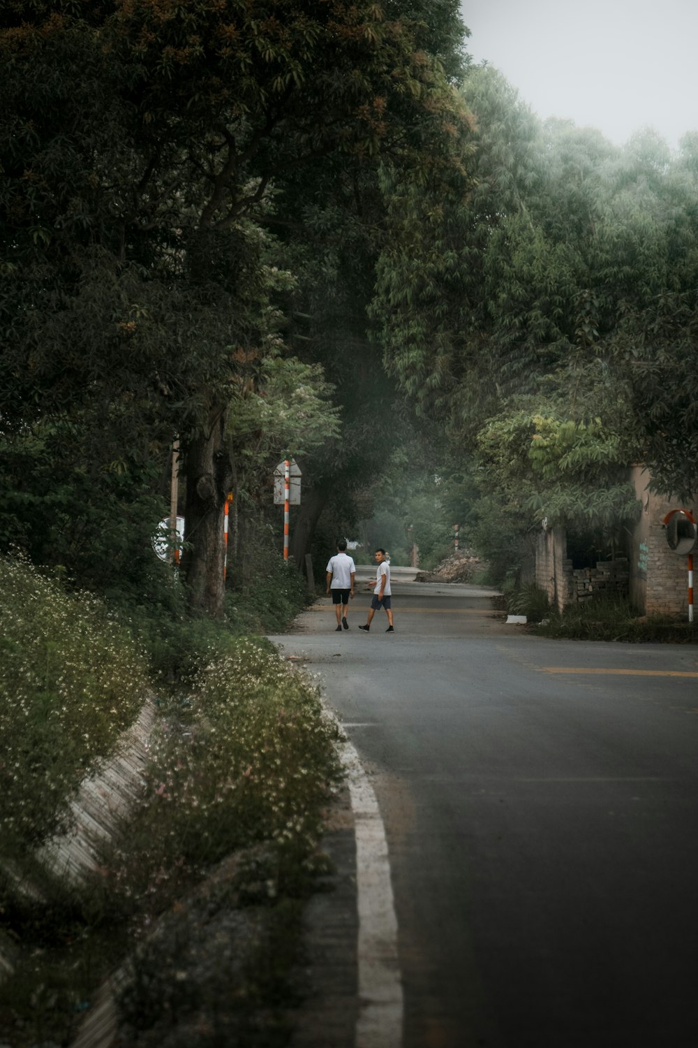 a couple of people walking down a street