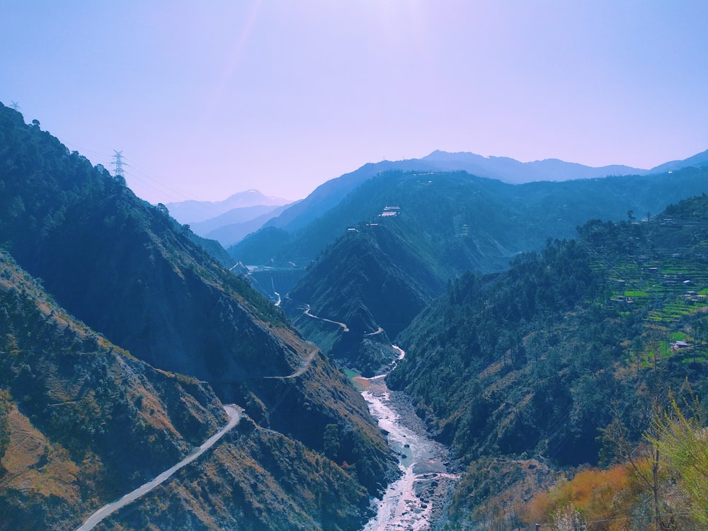 a river running through a valley surrounded by mountains