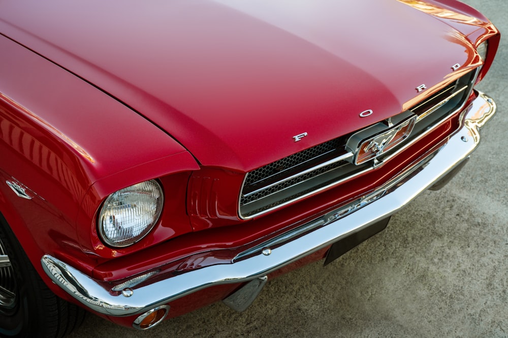 a close up of the front of a red mustang