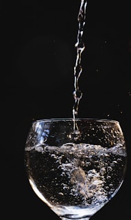 A close-up of clean water being poured into a tank.