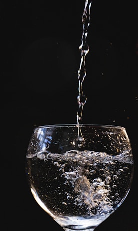 A close-up of clean water being poured into a glass.