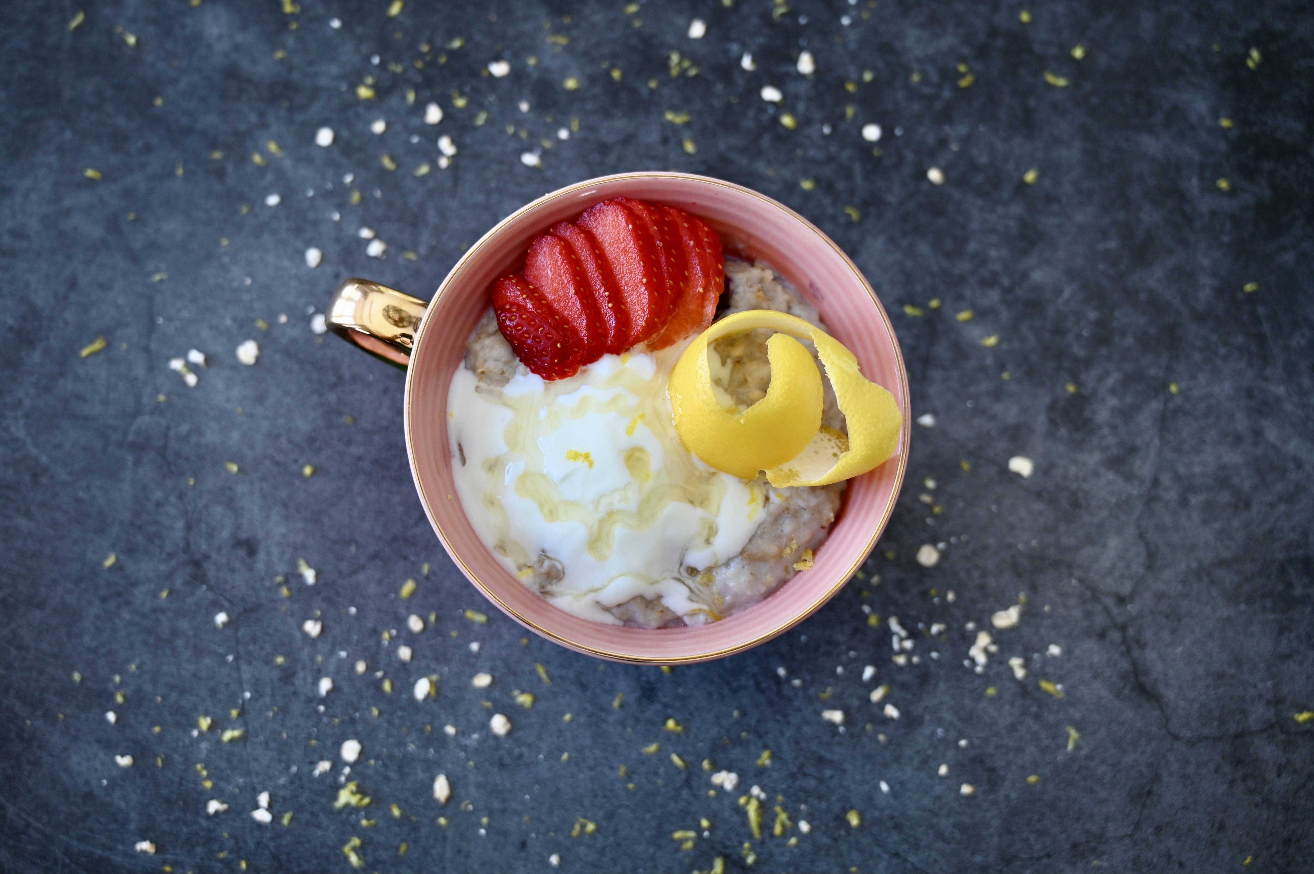 a bowl of oatmeal topped with sliced strawberries