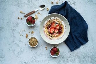 a bowl of yogurt with strawberries and granola