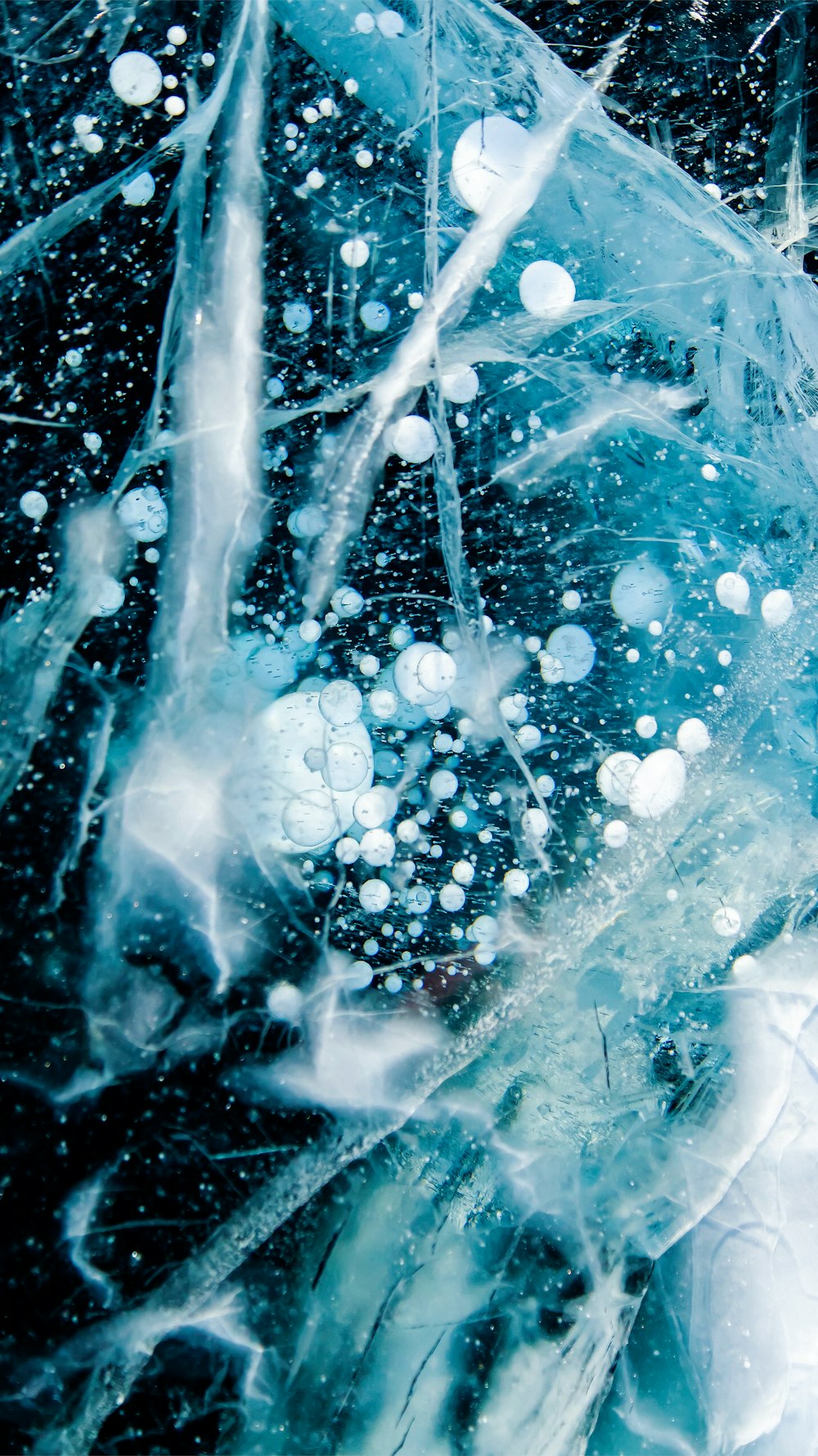 a close up of ice and water on a black background