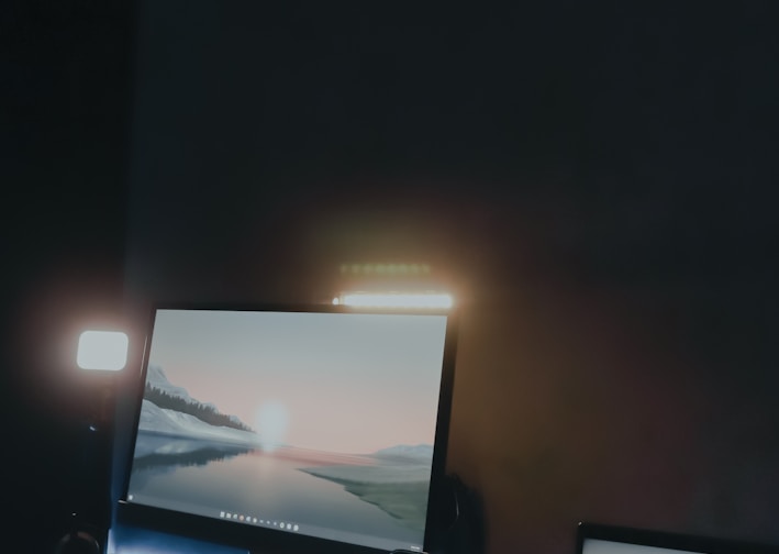 a desk with two laptops and a phone on it