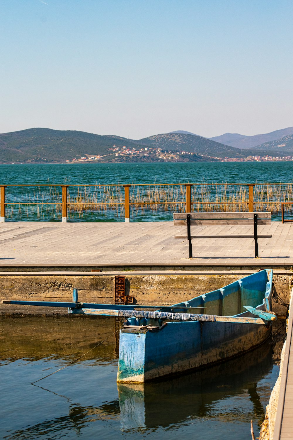 a blue boat sitting on top of a body of water