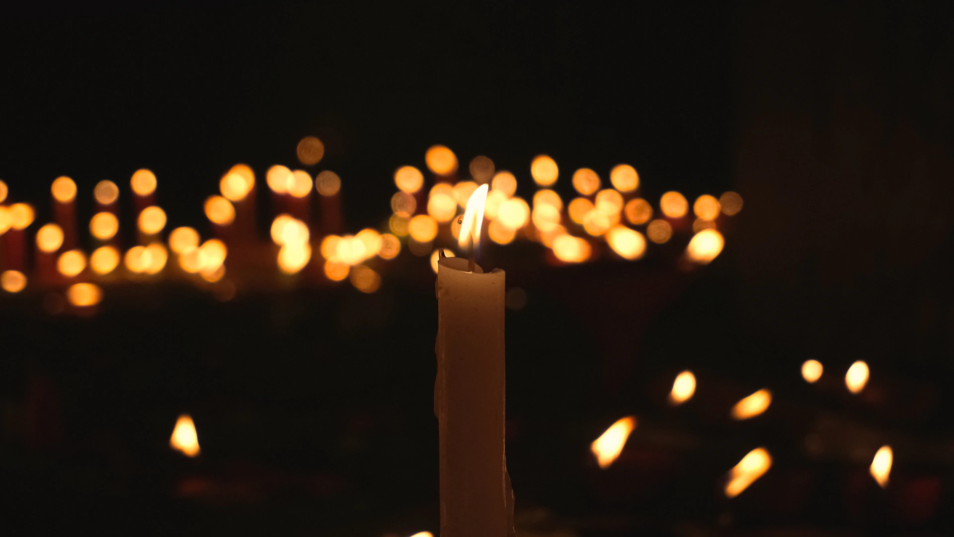 a candle is lit in a dark room