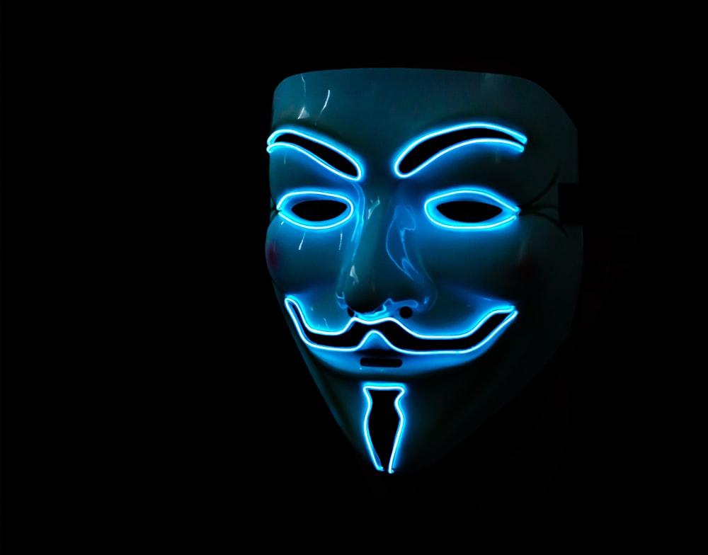 a person wearing a blue mask with a black background