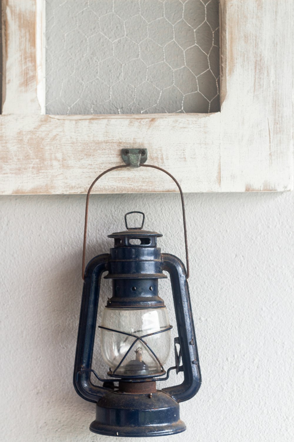 an old fashioned lantern hanging on a wall