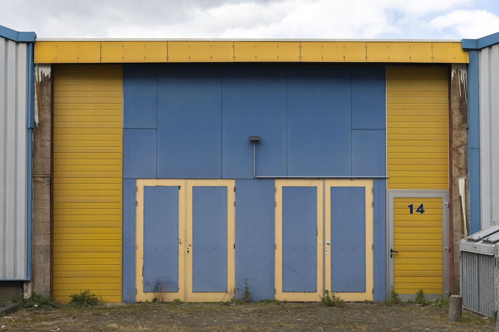 a yellow and blue building with two doors