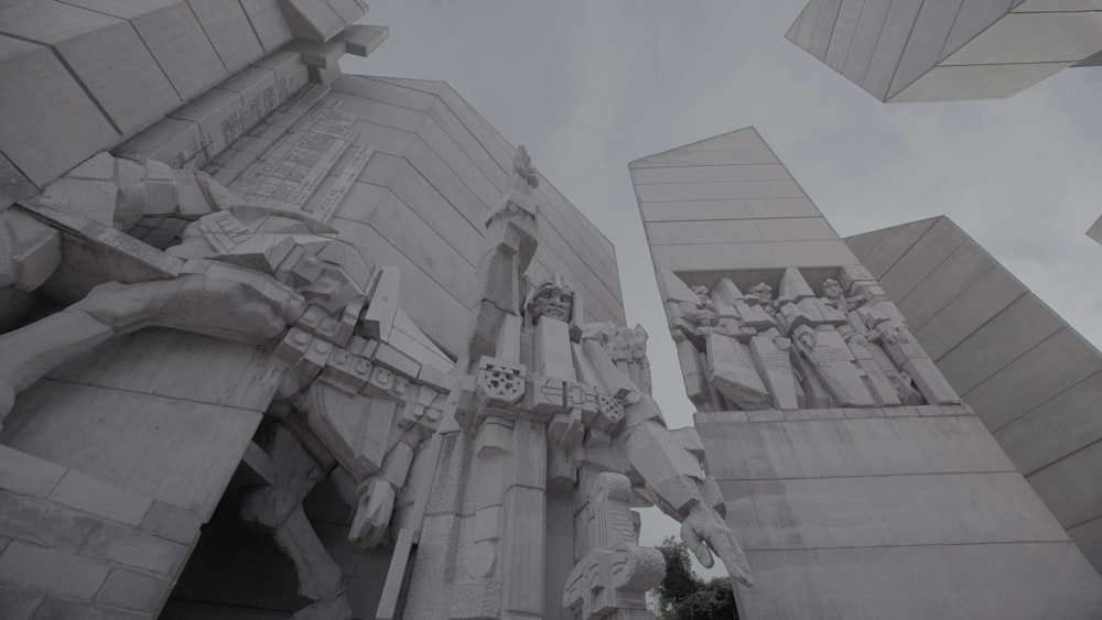 a black and white photo of a building with statues on it