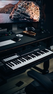 a computer desk with a keyboard and a monitor