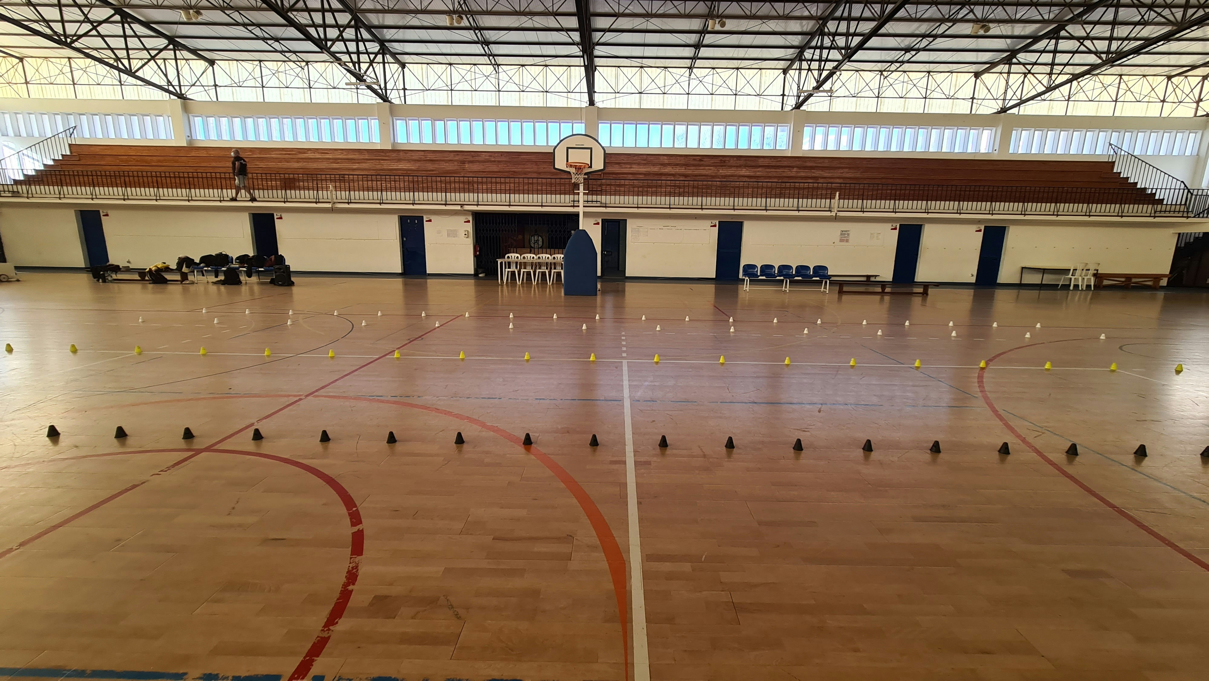 a gym with a basketball court and a basketball hoop