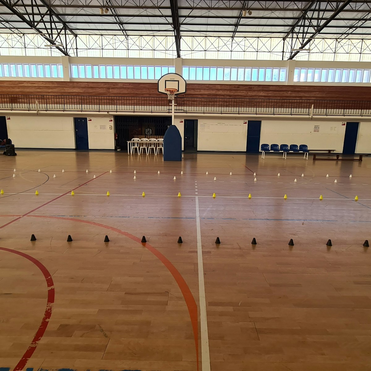 Horton gymnasium floor and hoop, shot level from the baseline.