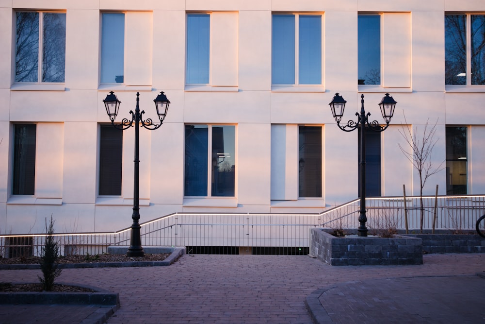 a couple of street lamps sitting in front of a building