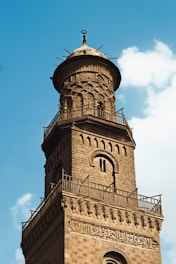 a tall tower with a clock on the top of it
