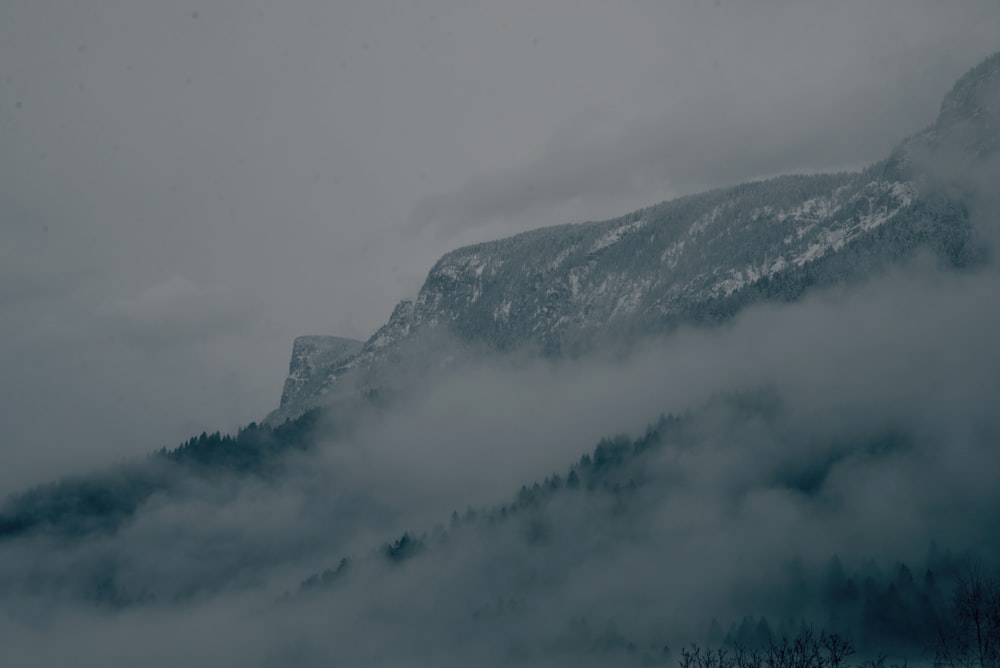 a mountain covered in fog and low lying clouds