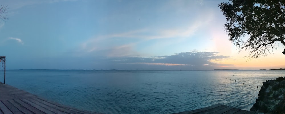 a wooden dock sitting next to a large body of water