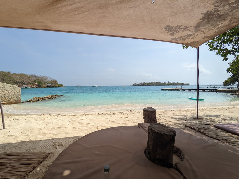 a view of a beach from under an umbrella