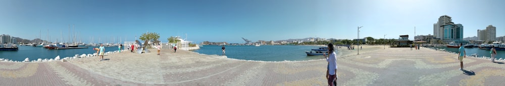 a panoramic view of a beach with boats in the water