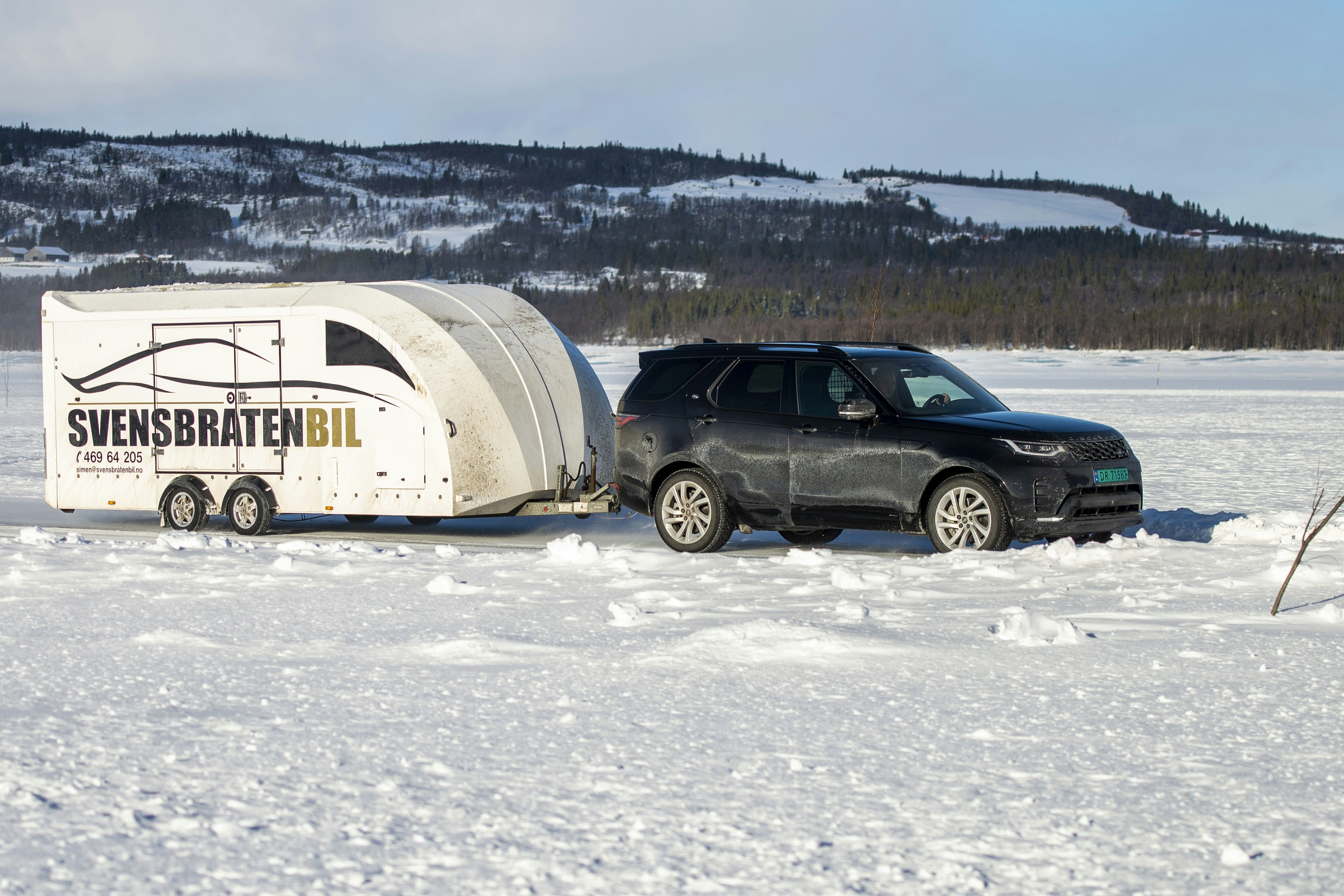 A truck towing a trailer in the snow photo Free Grey Image on Unsplash