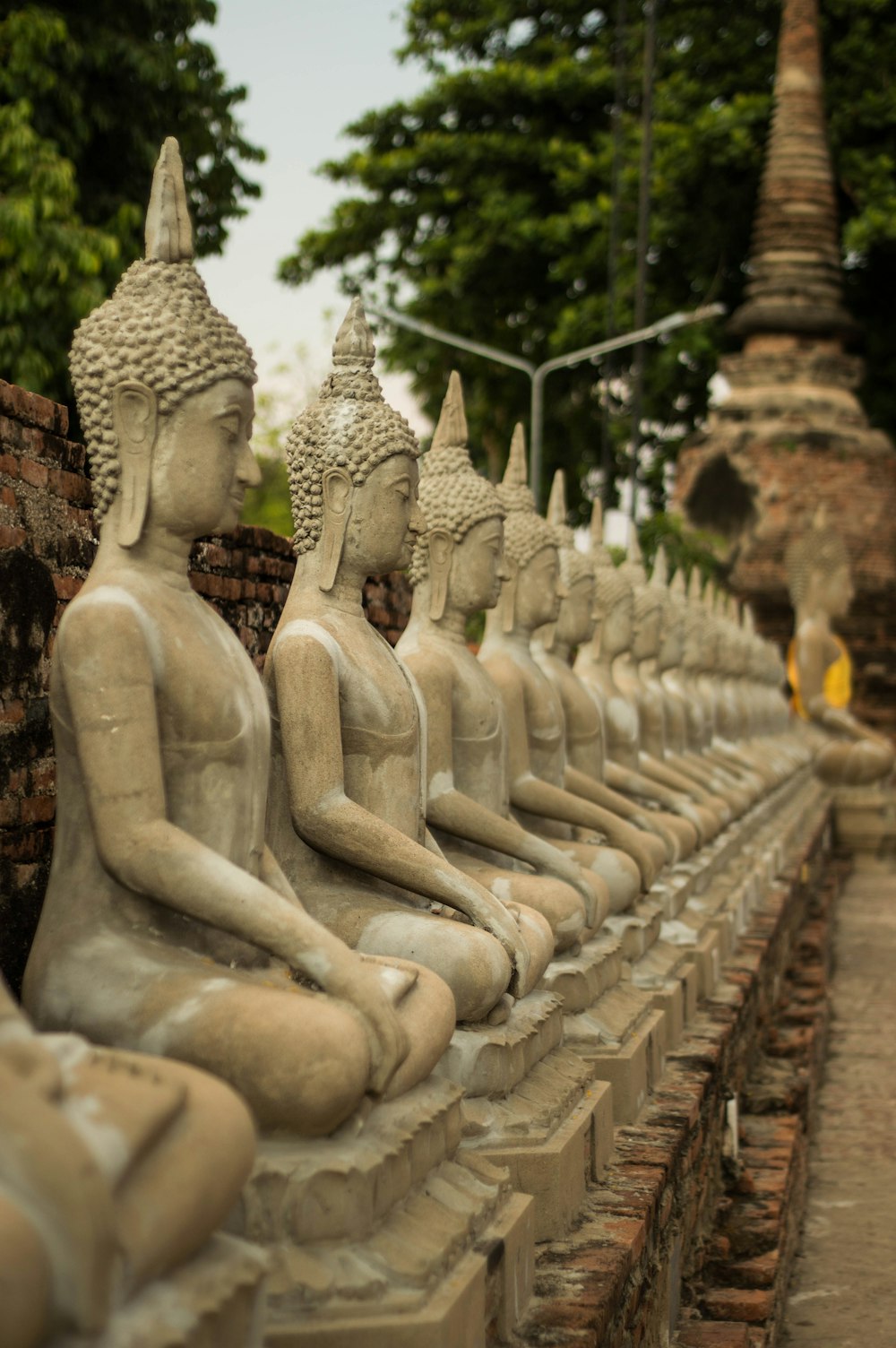 a row of buddha statues sitting next to each other